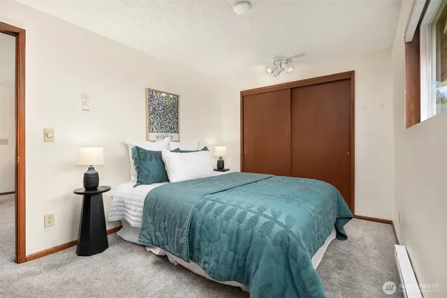 a bedroom with a bed and a window