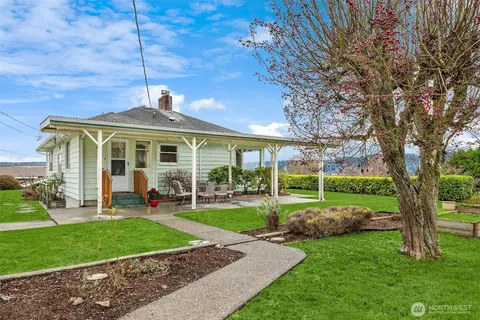 a front view of a house with a yard table and chairs