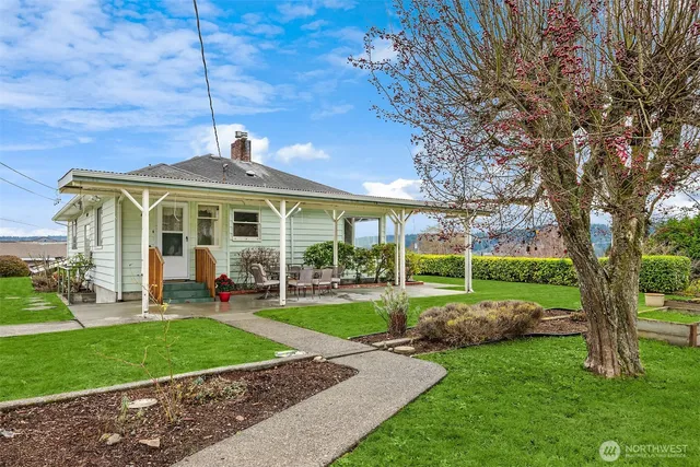 a front view of a house with a yard table and chairs