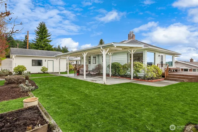 a front view of a house with a garden