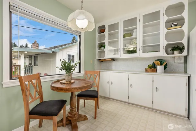 a view of a dining room with furniture and chandelier