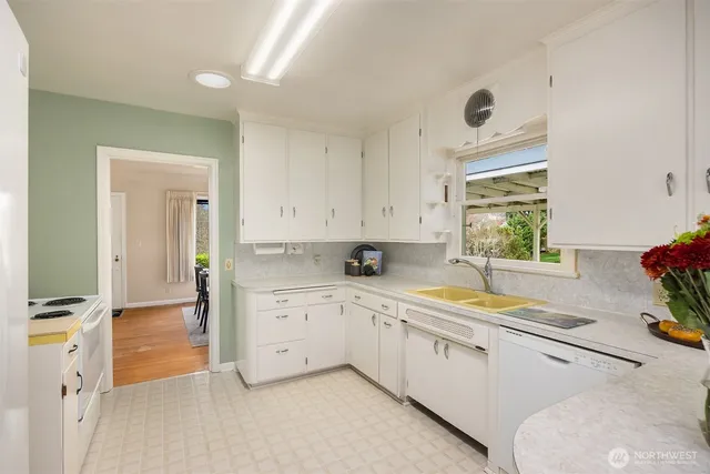 a kitchen with a sink cabinets and window