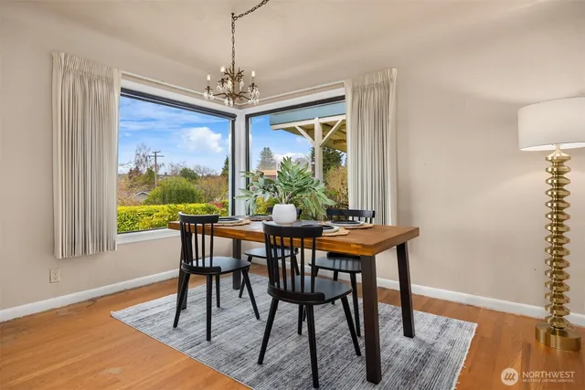 a view of a dining room with furniture window and wooden floor