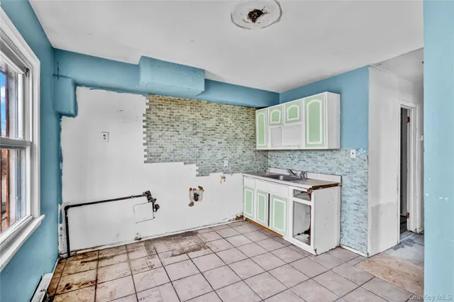 a kitchen with granite countertop white cabinets and stainless steel appliances