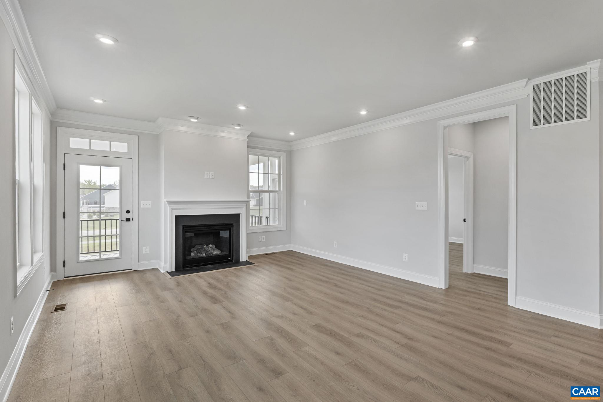 200 Marcella Street Charlottesville, VA 22911 - Photo 12 of 57 a view of an empty room with wooden floor fireplace and a window