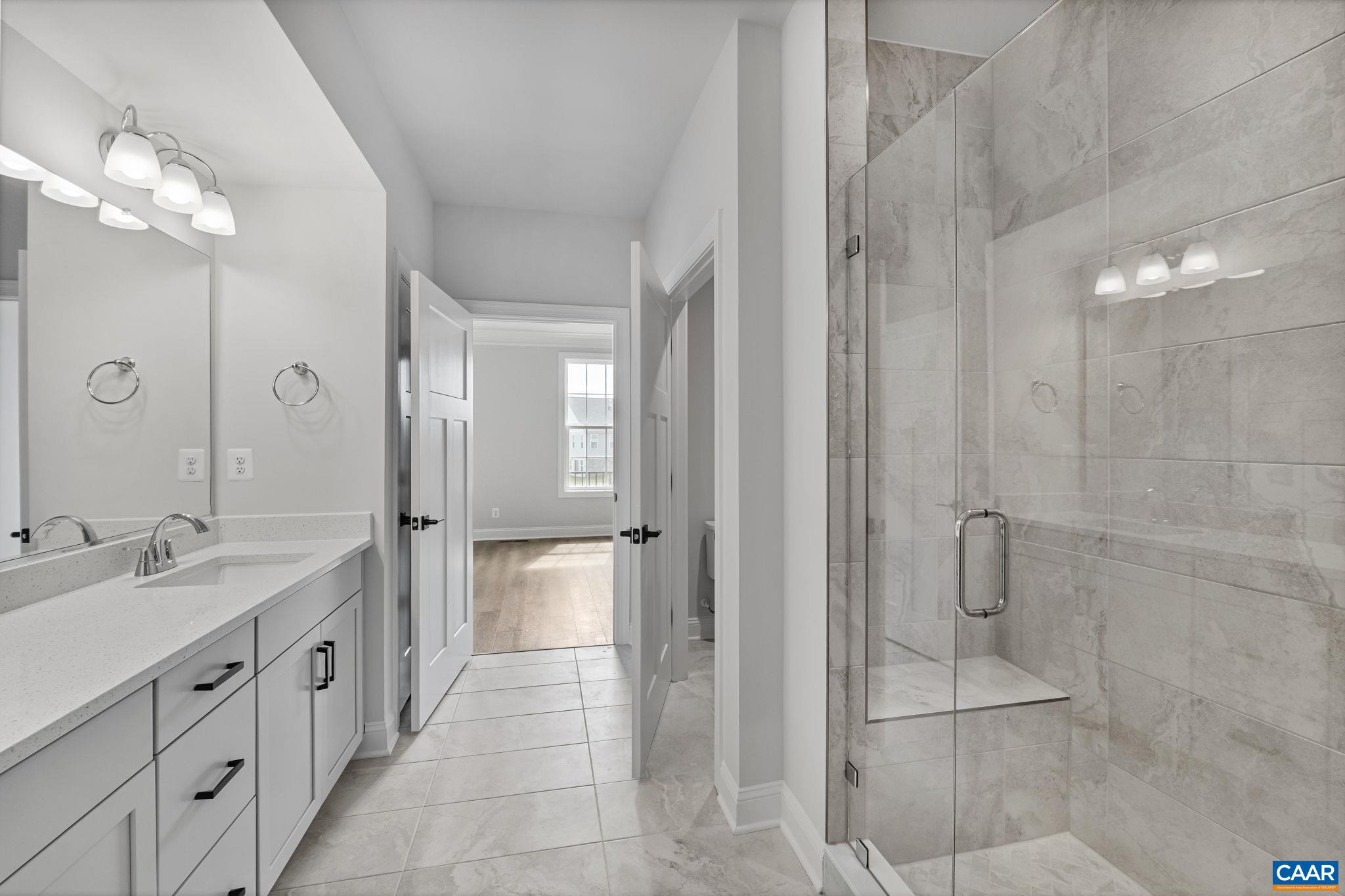 200 Marcella Street Charlottesville, VA 22911 - Photo 21 of 57 a spacious bathroom with a double vanity sink a large mirror and shower