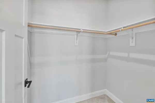 a view of an empty room with a kitchen