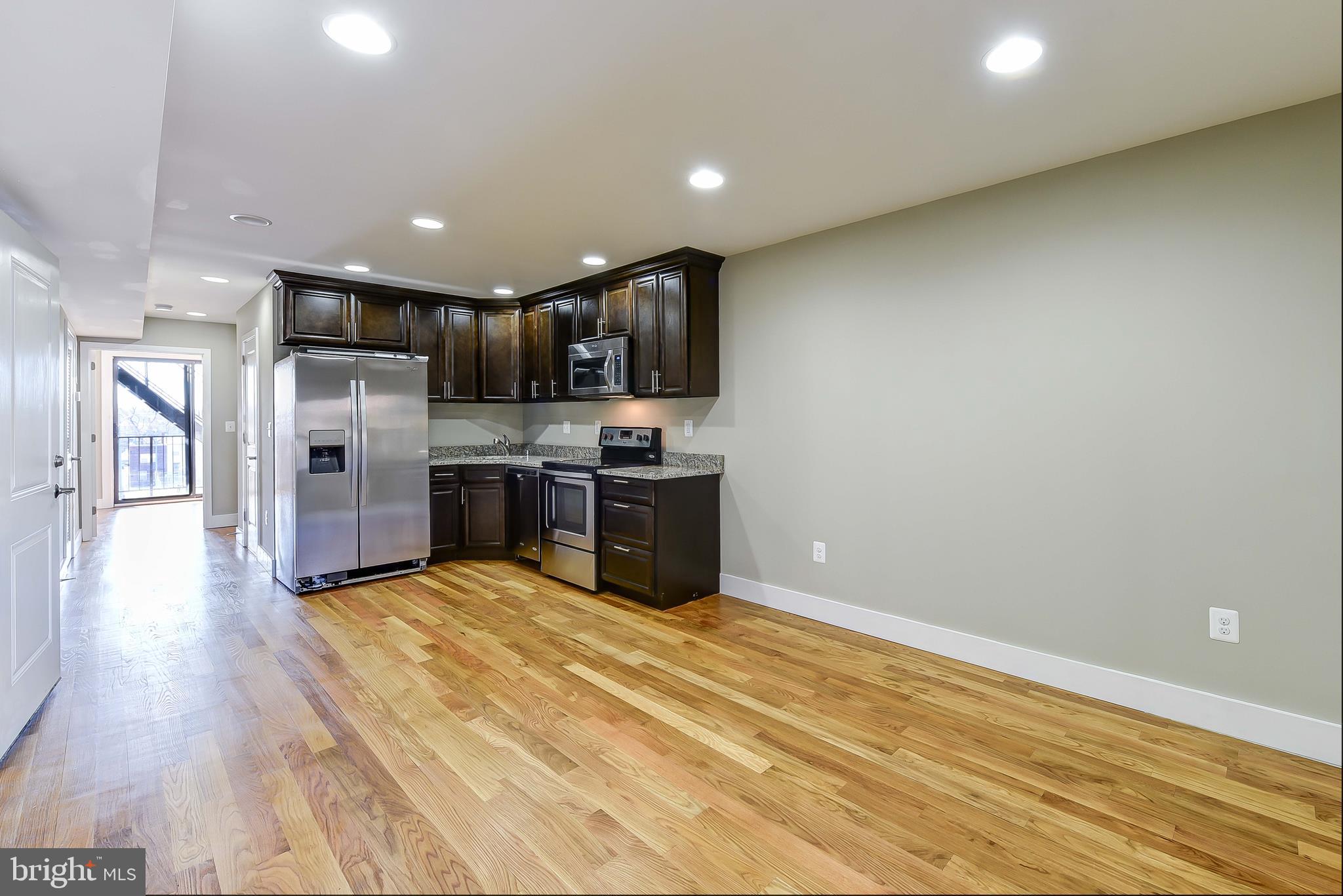 2031 Benning Road Northeast, Unit B Washington, DC 20002 - Photo 4 of 22 a kitchen with stainless steel appliances a refrigerator and a stove top oven