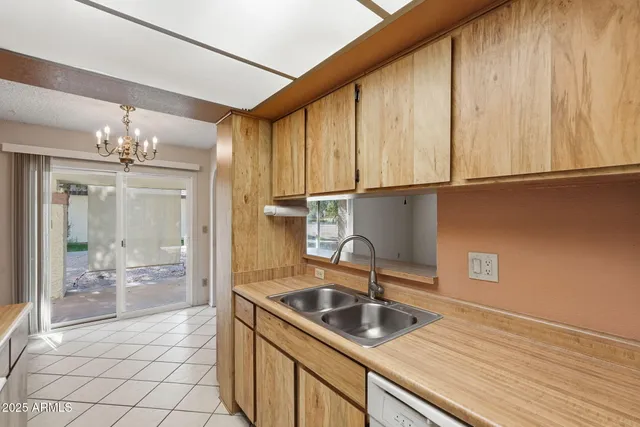a kitchen with stainless steel appliances granite countertop a sink a refrigerator and a stove top oven