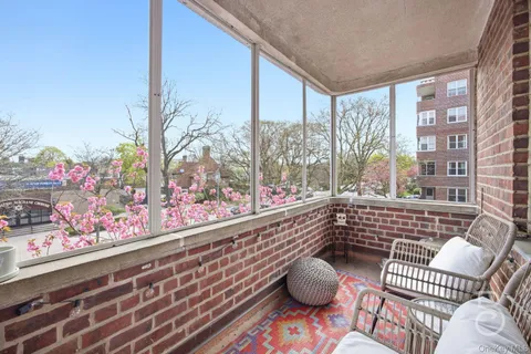 a very nice looking room with wooden floor and a potted plant