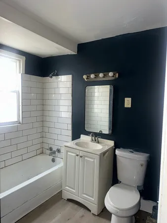 a bathroom with a sink a toilet and bathtub