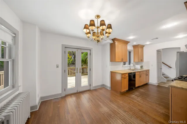 a view of an empty room with window and fire place