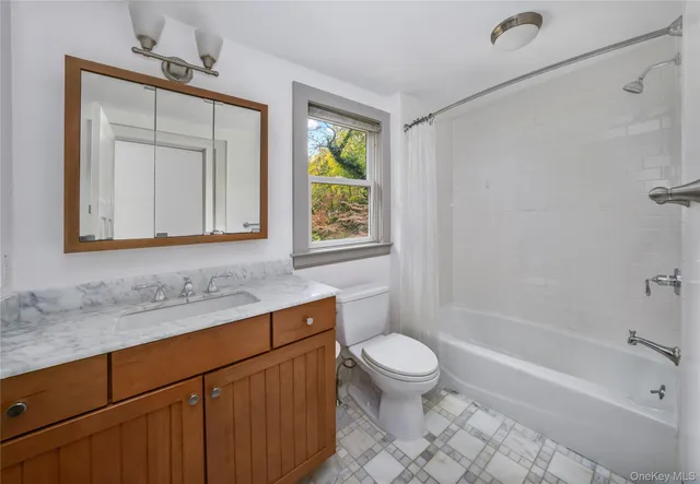 a bathroom with a sink a toilet and bathtub