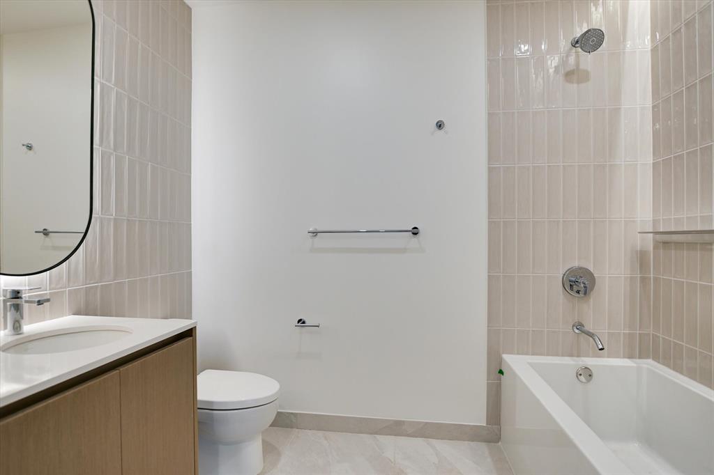 610 Davis Street, Unit 2708 Austin, TX 78701 - Photo 11 of 35 Full bathroom with vanity, shower / bathtub combination, and tile walls