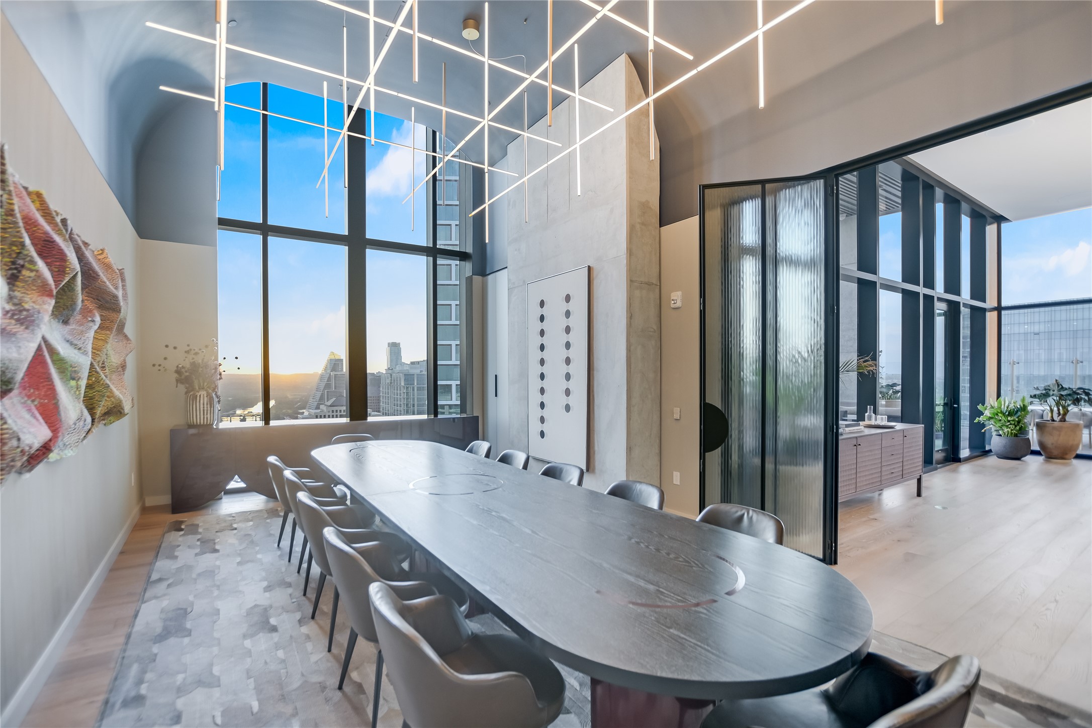 610 Davis Street, Unit 2708 Austin, TX 78701 - Photo 18 of 35 Dining room featuring a towering ceiling, wood finished floors, and a view of city