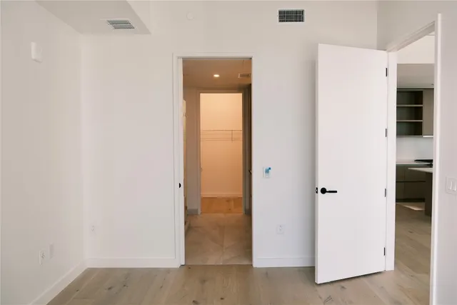 a view of an empty room with glass door