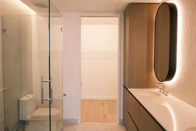 a bathroom with a sink a toilet and a mirror