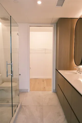 a bathroom with a sink mirror vanity and toilet