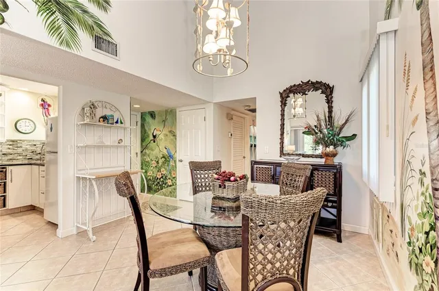 a view of a dining room with furniture and a chandelier