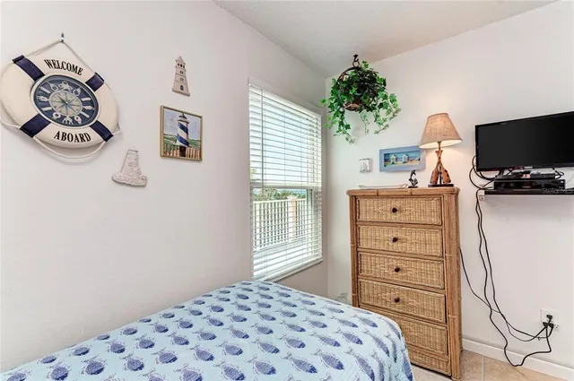 a bedroom with a bed and a television