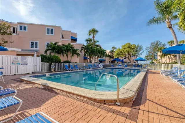 a view of a swimming pool with a lounge chairs