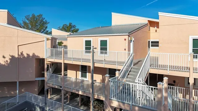 a kitchen with cabinets a sink and white appliances