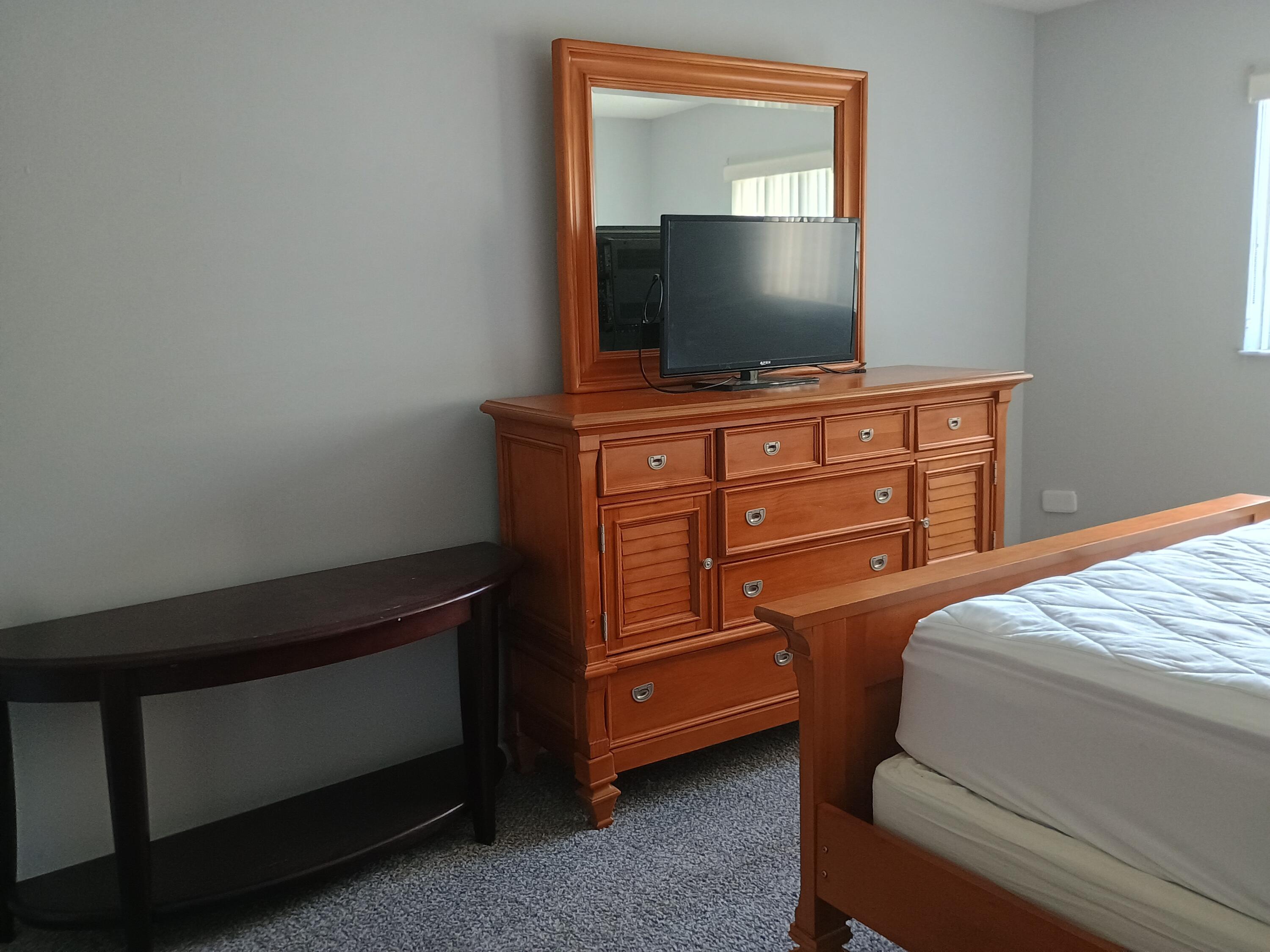 3 Colonial Club Drive, Unit 100 Boynton Beach, FL 33435 - Photo 13 of 26 a bedroom with a bed and flat screen tv