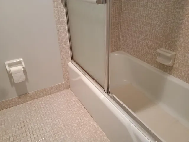 a white toilet sitting next to a bathroom sink
