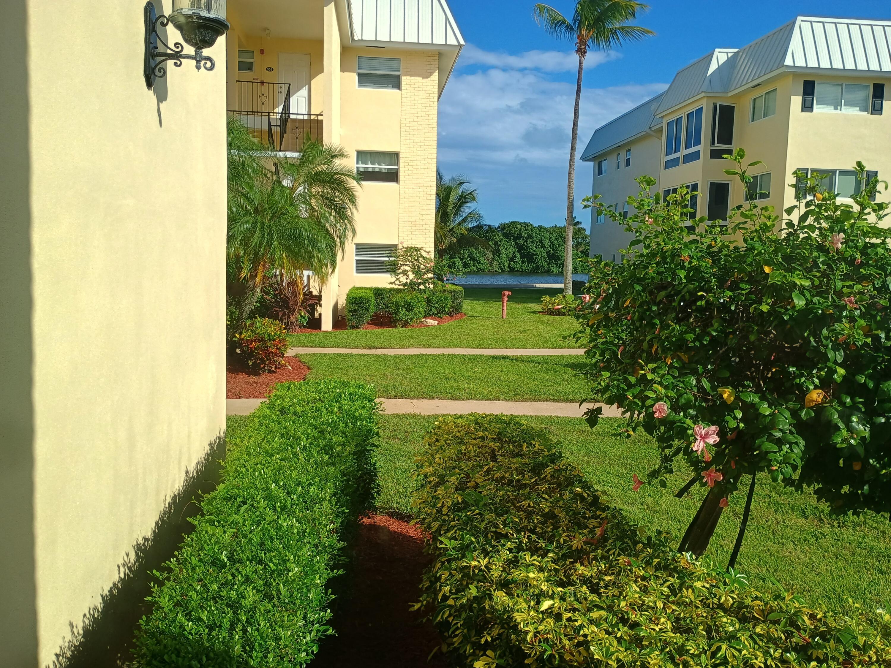 3 Colonial Club Drive, Unit 100 Boynton Beach, FL 33435 - Photo 2 of 26 a view of a big yard next to a building