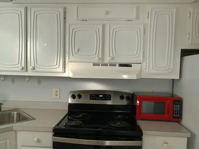 a stove top oven sitting inside of a kitchen