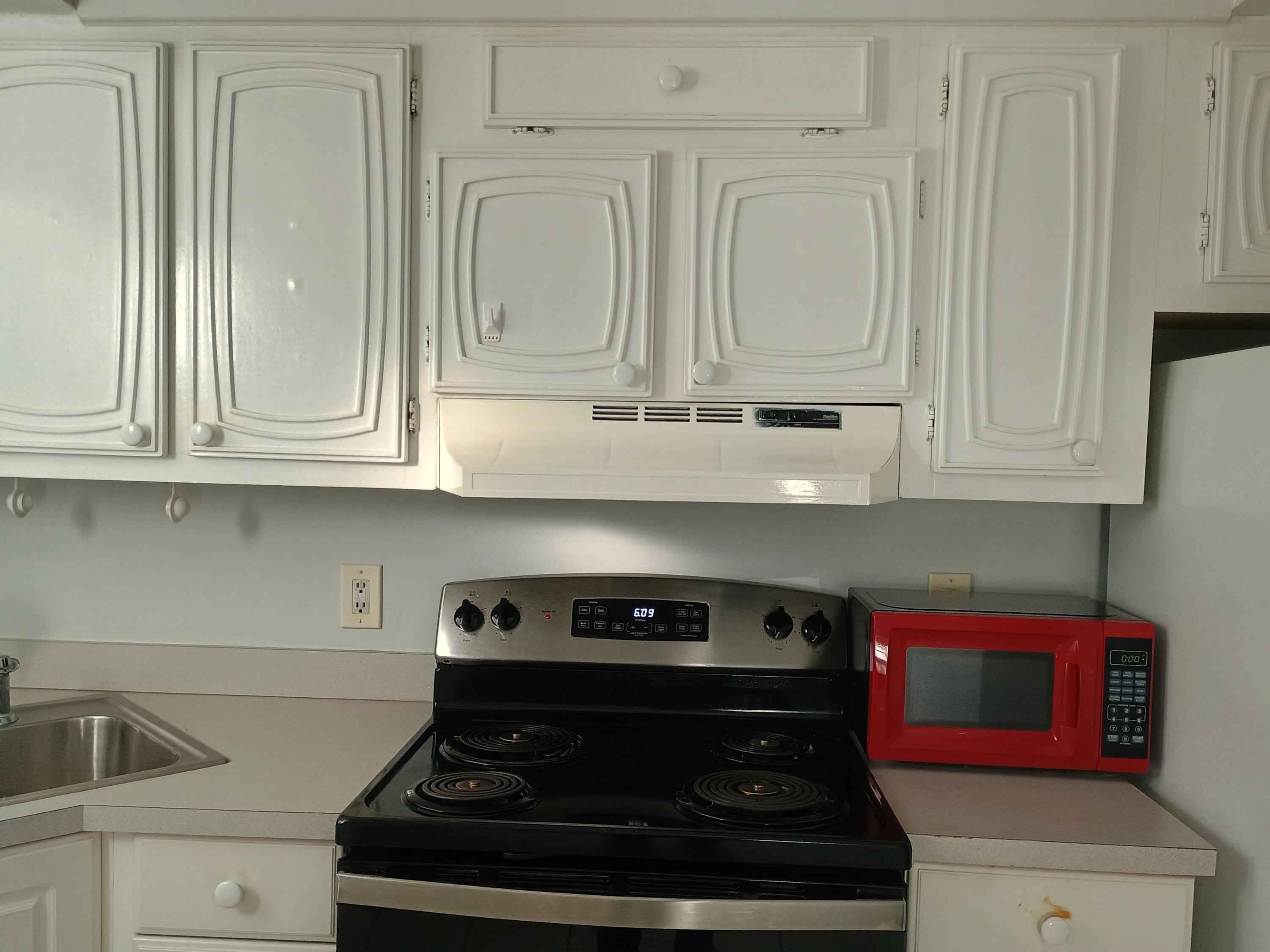 3 Colonial Club Drive, Unit 100 Boynton Beach, FL 33435 - Photo 7 of 26 a stove top oven sitting inside of a kitchen