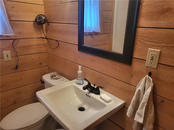 a bathroom with a sink mirror and toilet