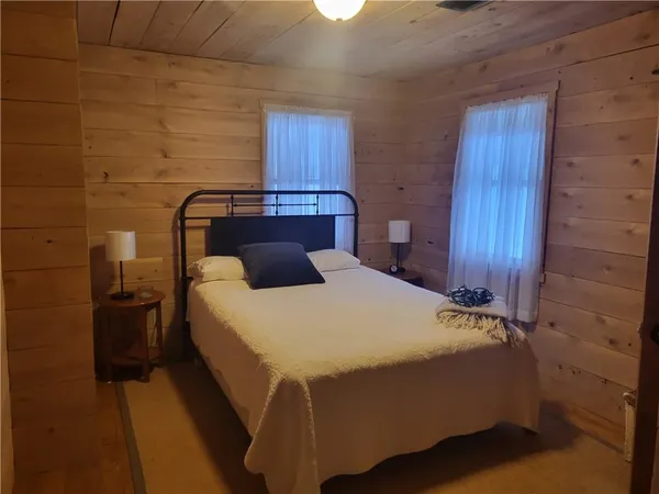 a bed sitting in a bedroom next to a wooden door