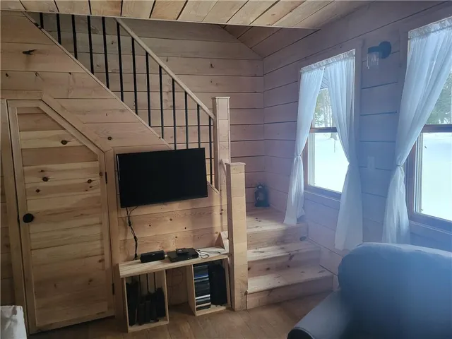 a view of a hallway with stairs and furniture