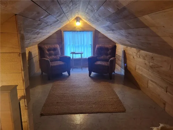a view of living room filled with furniture and a fireplace