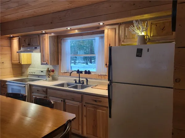 a kitchen with a sink a refrigerator a stove and a refrigerator