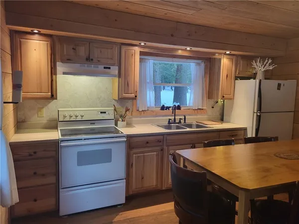 a kitchen with a sink stove and refrigerator