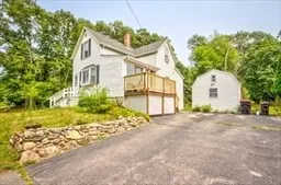 a view of a house with a yard and potted plants
