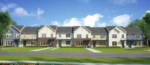 a front view of a house with a yard and trees