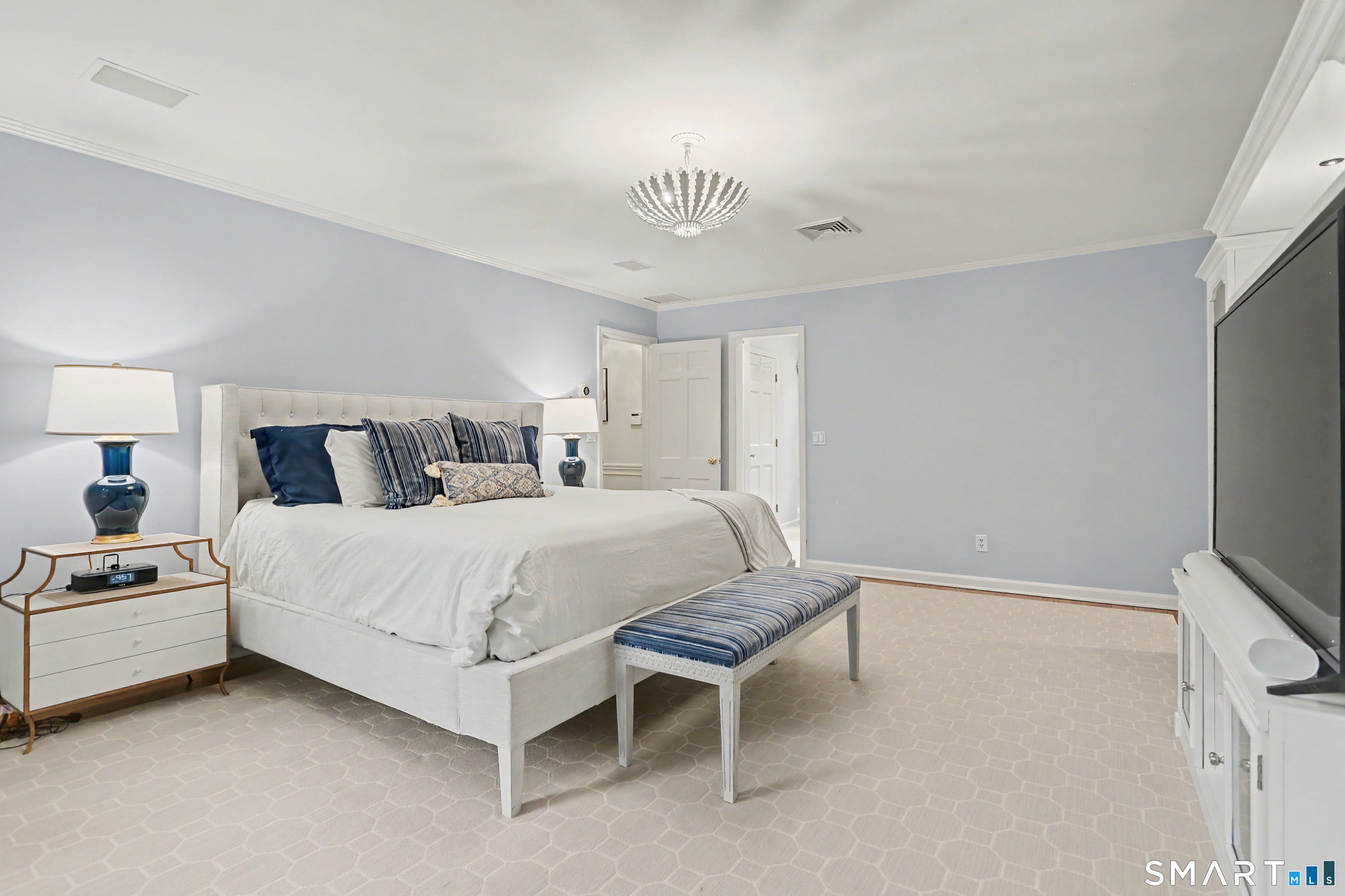108 Logan Road New Canaan, CT 06840 - Photo 20 of 40 a bedroom with a bed and a chandelier