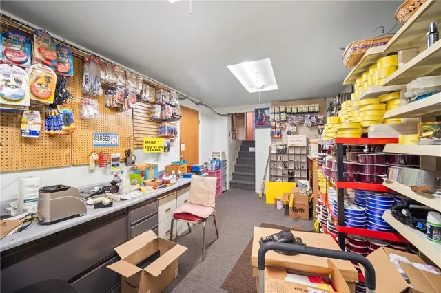a room with furniture a rug toys and a window