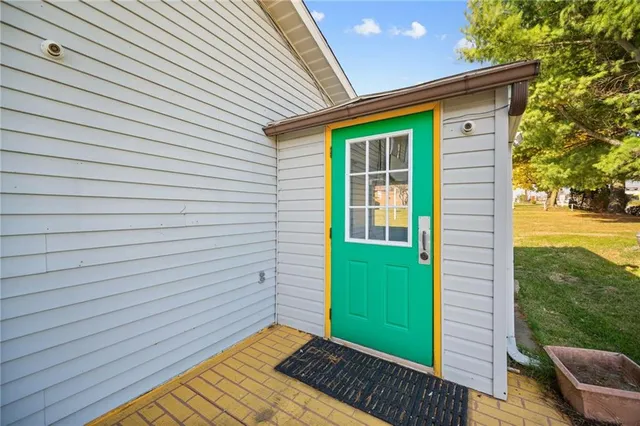 a view of a house with pool and chairs