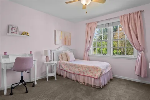 a bedroom with a bed chair and a window