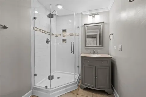 a bathroom with a shower sink and mirror