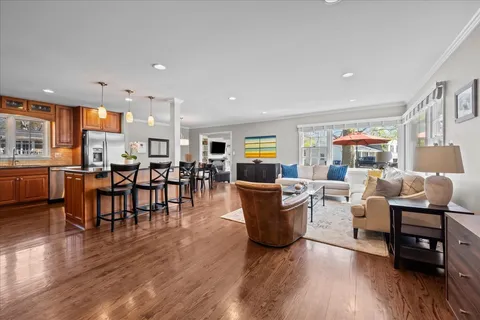 a living room with lots of furniture and kitchen view