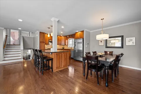 a view of a dining room with furniture and wooden floor