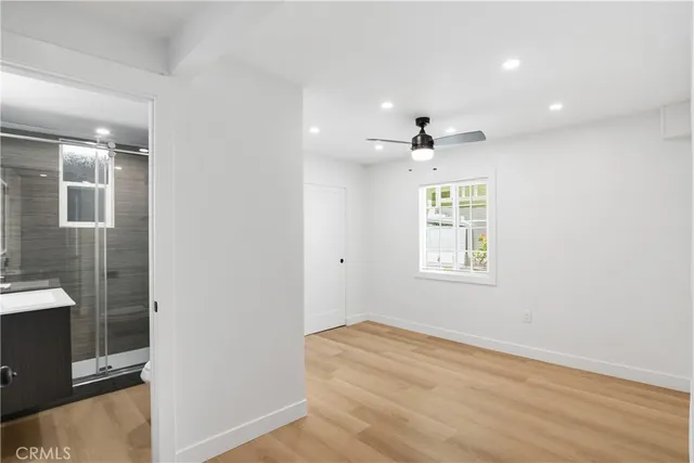 a kitchen with stainless steel appliances a refrigerator sink and white cabinets