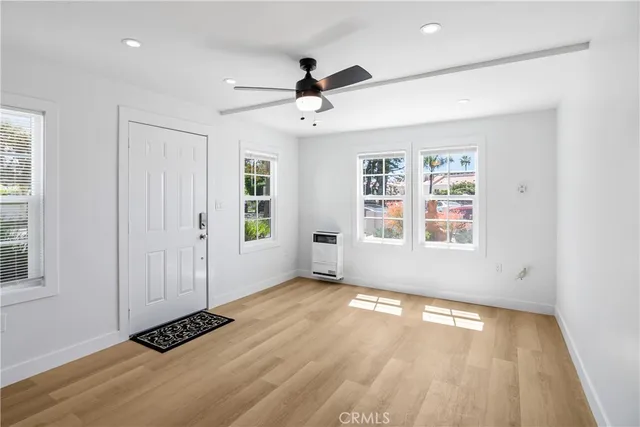 a kitchen with stainless steel appliances granite countertop white cabinets and window