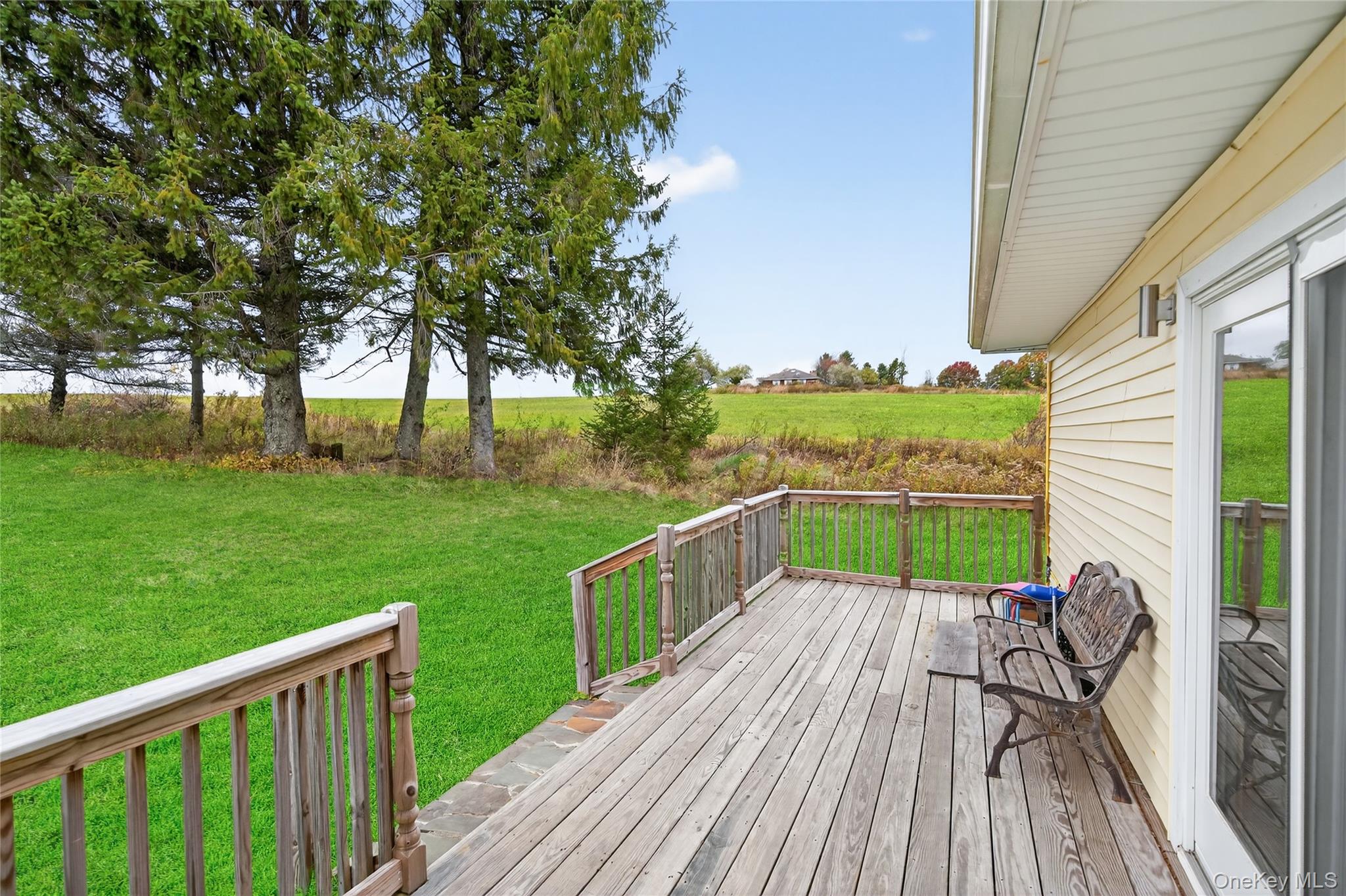 6049 State Rte 55 Liberty, NY 12754 - Photo 35 of 50 a view of a deck with chairs and a yard with wooden fence