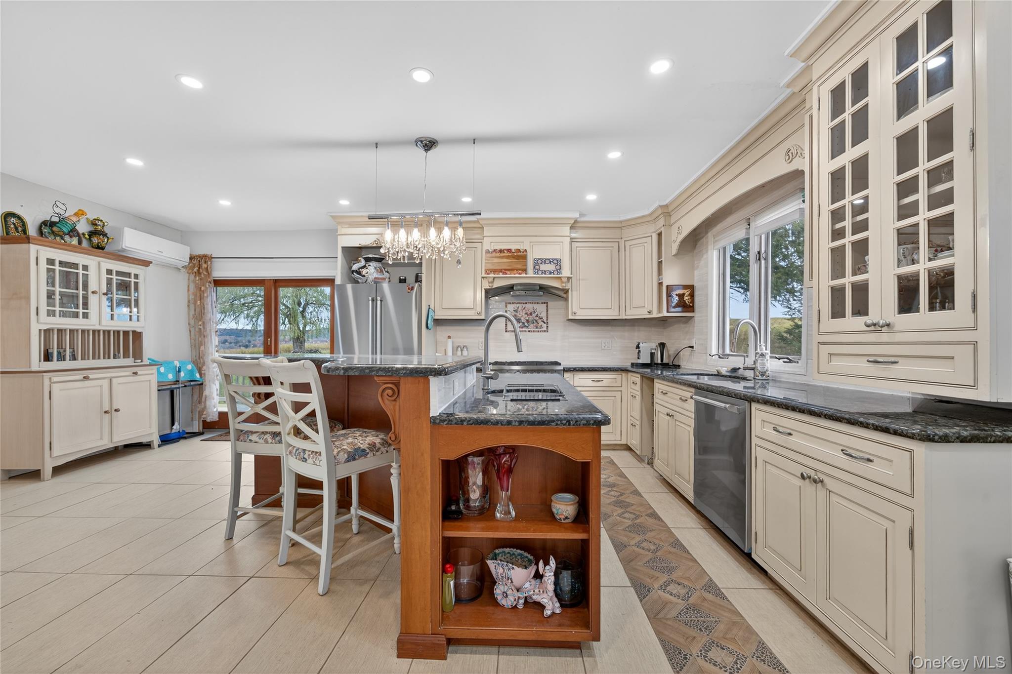 6049 State Rte 55 Liberty, NY 12754 - Photo 6 of 50 a kitchen with stainless steel appliances granite countertop a stove top oven a sink a dining table and chairs with wooden floor